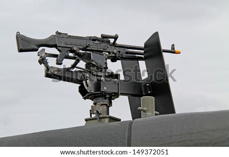 A Machine Gun Mounted on the Top of a Military Vehicle.