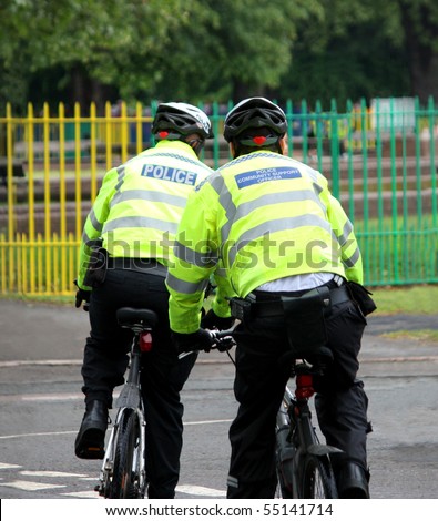 Two Law Enforcement Officers Riding on Bicycles.