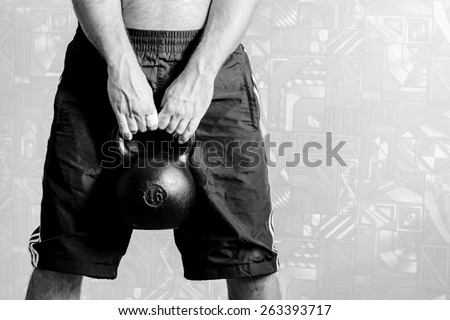 Lower body background with kettlebell. Black-and-white, horizontal