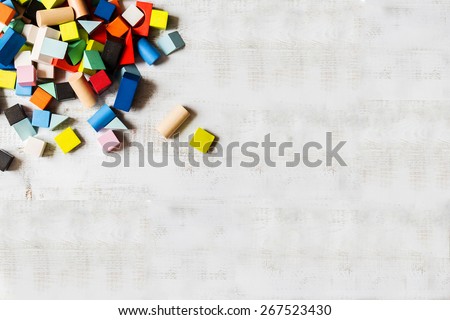 Scattered heap of toy colored wooden bricks background