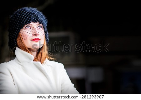 Portrait of mysterious beautiful ginger hair young woman lifting her eyes up