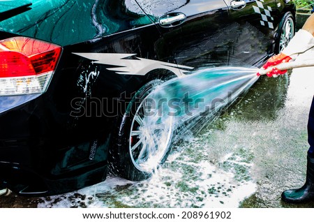 Car wash with flowing water and foam.