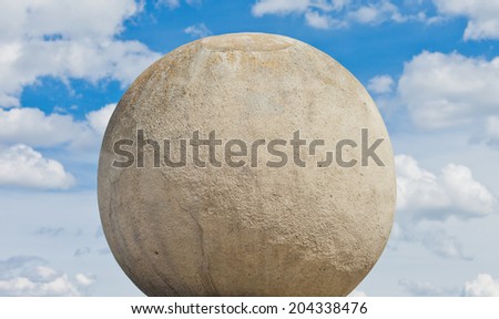Stone (concrete) sphere against a sky background