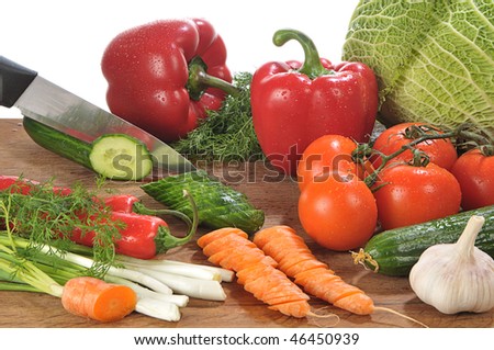 close-up shot of someone cutting up colorful different vegetables