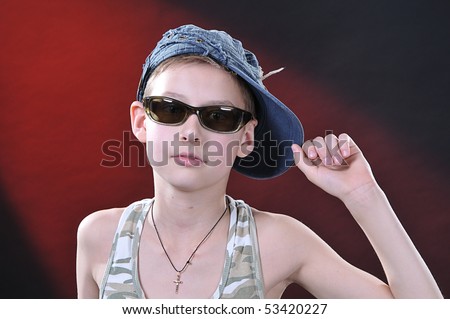 portrait of is ten or eleven years old boy in a jean cap and sun glasses