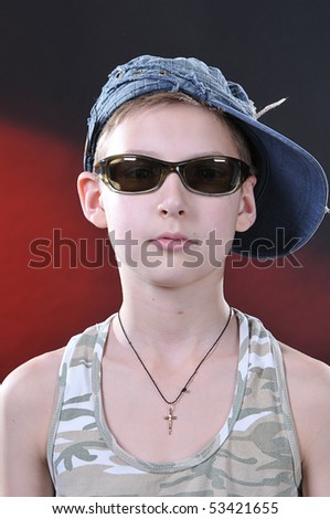 portrait of is ten years old boy in a jean cap and sun glasses