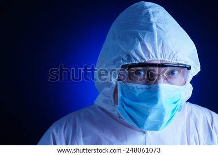Lab worker in protective suit and blue background