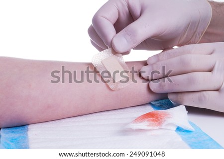 Adhesive Bandage. Bandaging at Wound by the Doctor