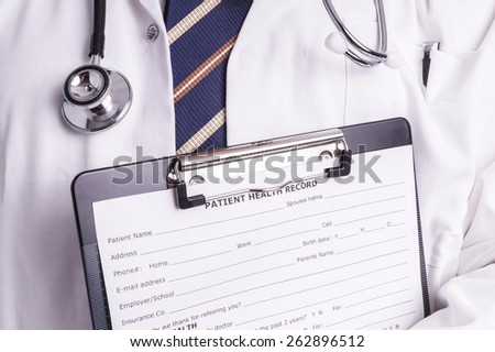 Male doctor fills patient registration prior to admission and examination. The doctor is thorough in completing properly so the patient gets the optimal treatment during his examination and illness
