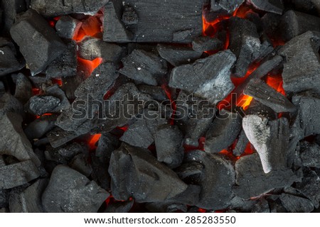 The heat of the burning wood and charcoal