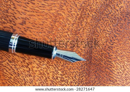 business fountain pen on a wood desktop in an office