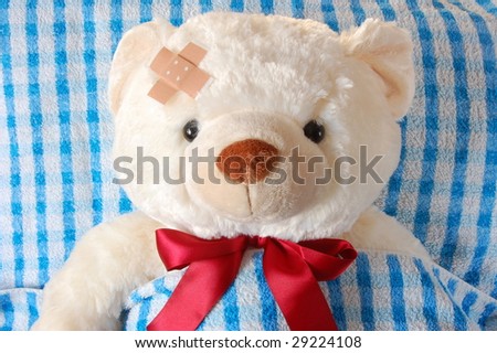 sick teddy bear in bed waiting for the doctor