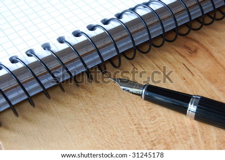 business fontain pen and ring book at the office