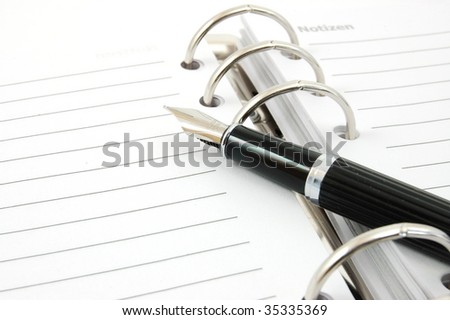 business pocket planner and pen ready to note an appointment