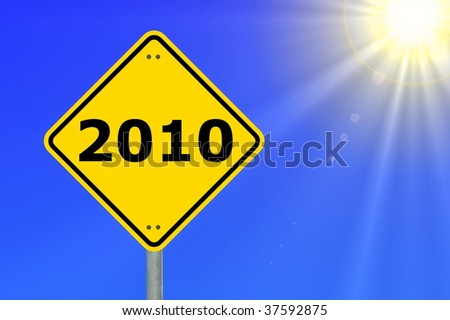 yellow road sign with year 2010 and blue sky
