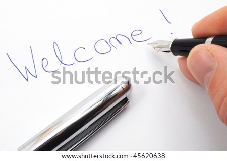 welcome message on sheet of paper with pen