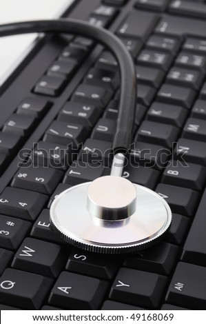 stethoscope on keyboard showing computer problem concept