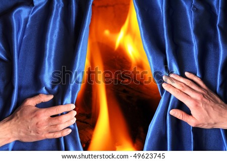 fire or flame hand and blue curtain with hand showing heat