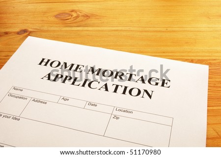 home mortgage application form on desktop in office showing real estate concept