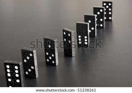 financial crisis concept with domino game on black background