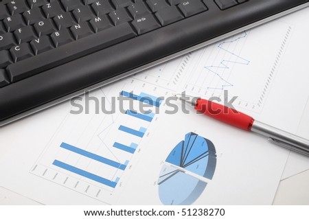 paperwork in office and computer keyboard showing success