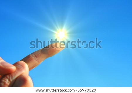 hand sun and blue sky with copyspace for text message