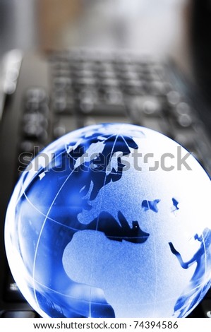 globalisation concept with glass planet on computer keyboard and copyspace