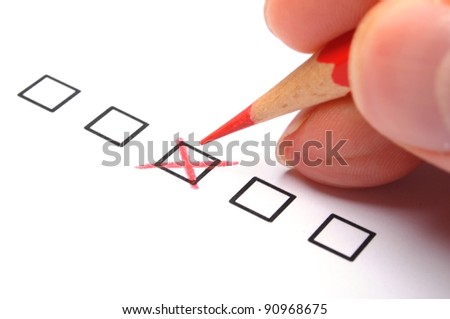 marketing concept with checkbox from questionnaire and red pencil