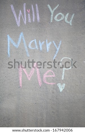 Will you marry me, a message written in chalk on the sidewalk.