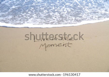 Live in the moment, a message written in the sand.