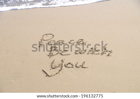 Peace be with you, a message written in the sand at the beach