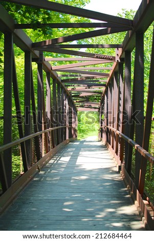 Walking bridge with with steel beams and a wood footpath