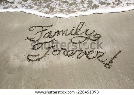 Family forever, a message written in the sand at the beach.