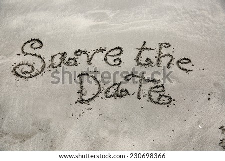 Save the date, a message written in the sand at the beach.