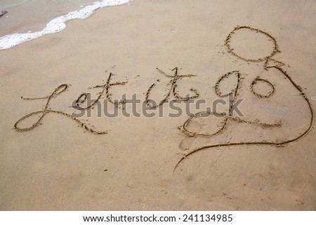 Let it go, a message written in the sand at the beach.