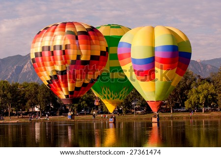 Hot air balloons over water.