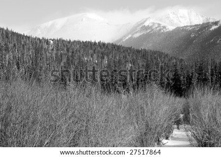 Snow capped Colorado Rocky Mountains photographed in black and white.