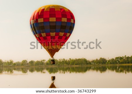 COLORADO SPRINGS - SEPTEMBER 6: A hot air balloon prepares to dip their basket in the lake at Colorado Springs Hot Air Balloon Festival September 6, 2009 in Colorado Springs, Colorado.