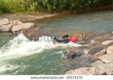 Man in kayak makes his way up river.