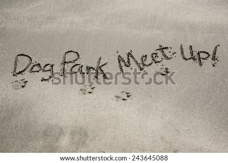 Dog Park meet up, a message written in the sand at the beach.
