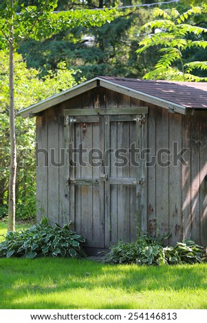 Backyard garden shack with old Barnwood; shed in a yard  with weathered wood