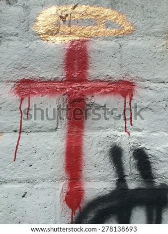 Graffiti art on a block wall in Sacramento, Red Cross painted on a cinder block wall