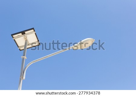 Led lighting and solar panel with blue sky background.