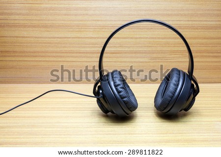Black Pair of Headphones on wood Background