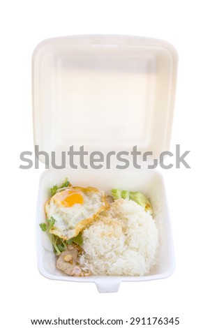 Basil fried rice with pork and fried egg in white foam box