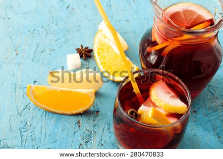 summer cocktail sangria with fruit in a basket. oranges, lemons, cinnamon