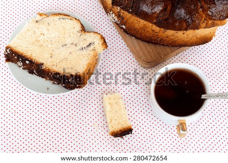 piece of loaf with a poppy and a cup of tea for breakfast, delicious poppy seed cake top view closeup