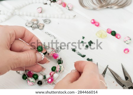 different beads made of glass and plastic, chains and tools for making jewelry