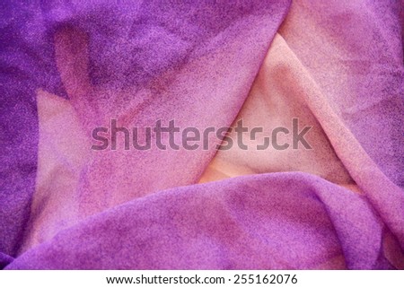 Texture of purple fabric with pleats. Shallow depth of field