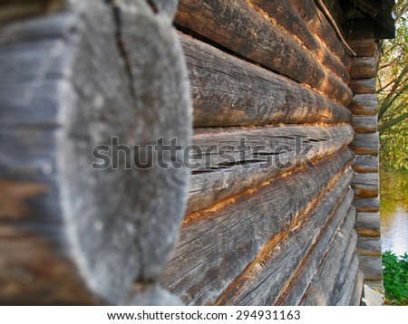 Wooden wall from boards of house. Shallow depth of field. Focus on the uneven bars